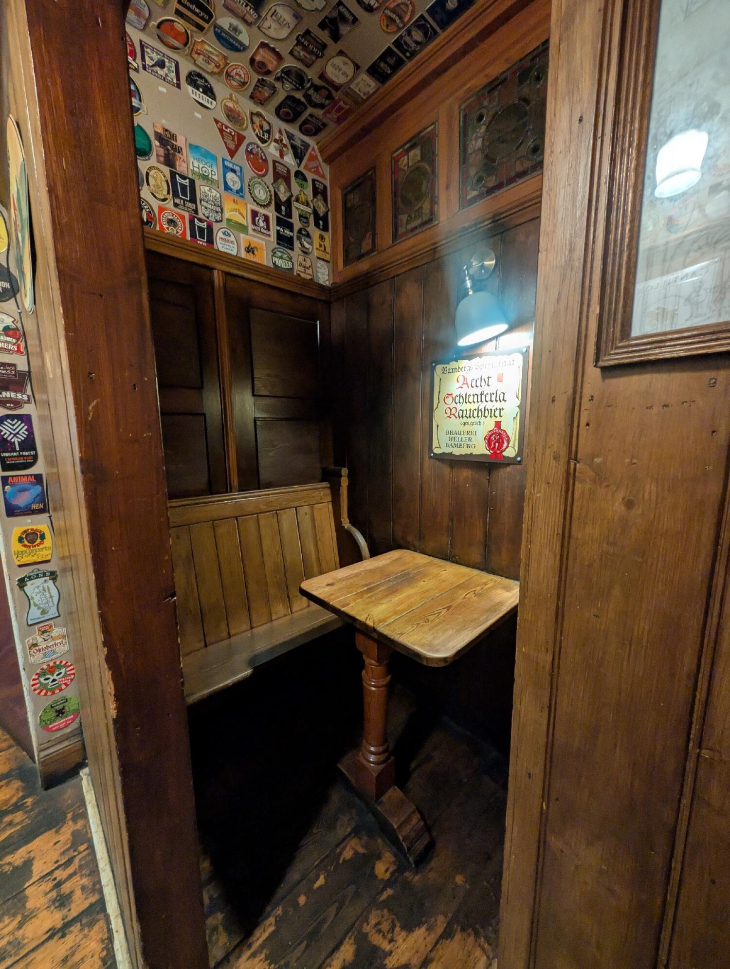 From radiator facing left. Wooden archway in front. Table and benches behind.