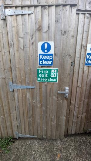 From back right of venue facing left. Wooden door ahead. Pull handle on right to open.