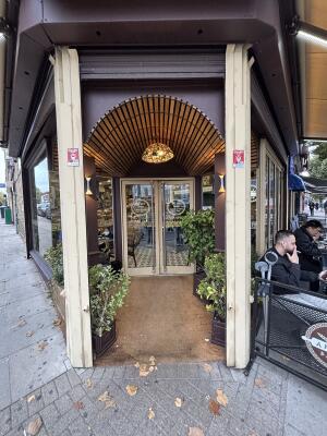 Open archway ahead. Planters to both sides.