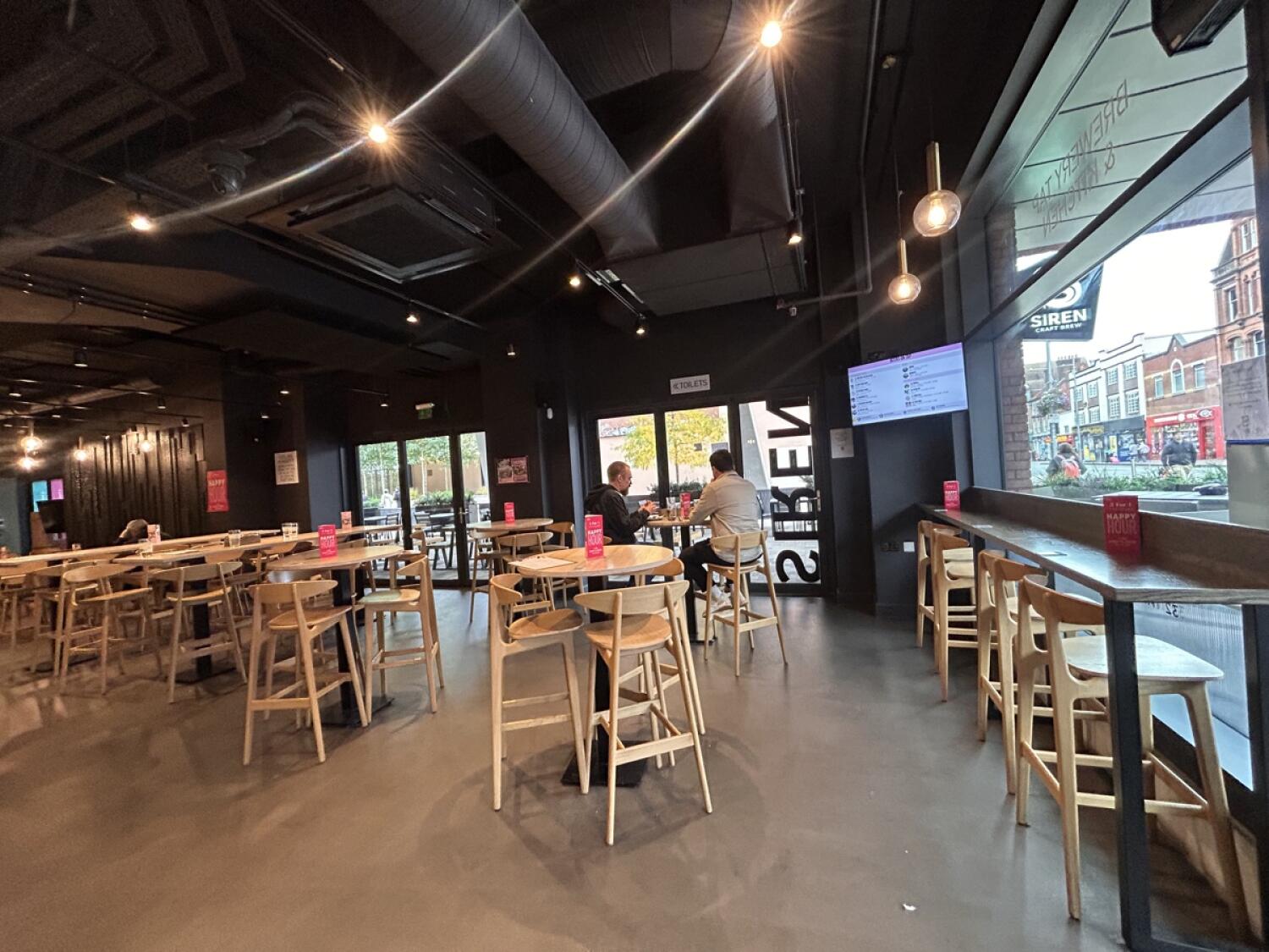 From entrance facing right. Stool and high-table on left and on right wall.