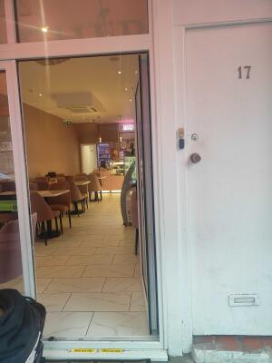 Glass door with white frames ahead. Push from left to open.