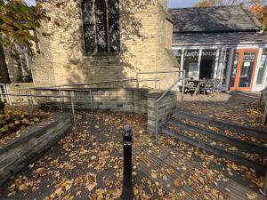 From street facing venue. Stairs to entrance on right. Built in ramp on left.