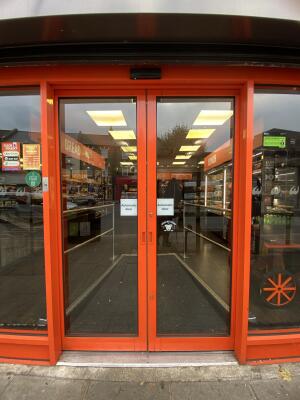 Orange framed glass door. Automatically open from centre.