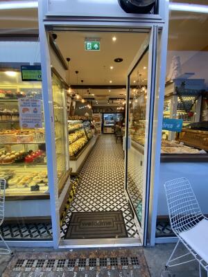 White framed glass door. Push from left to open.
