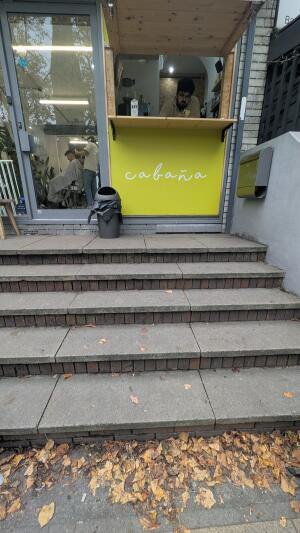 Open entrance to venue. Three steps ahead.