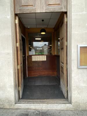 Brown wooden door. Push from centre to open.
