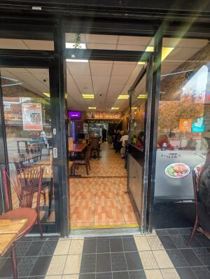 Black frame glass doors. Handle on right. Push to open.