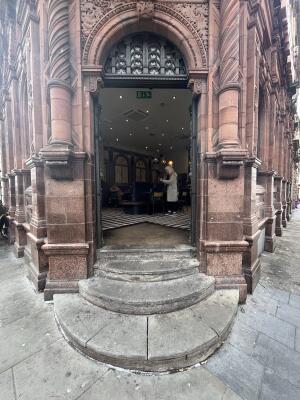 Black wooden double door with handles in centre. Push to open.