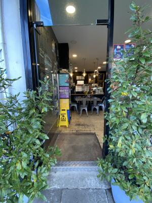 Black framed glass door. Push silver metal handle from right to open.
