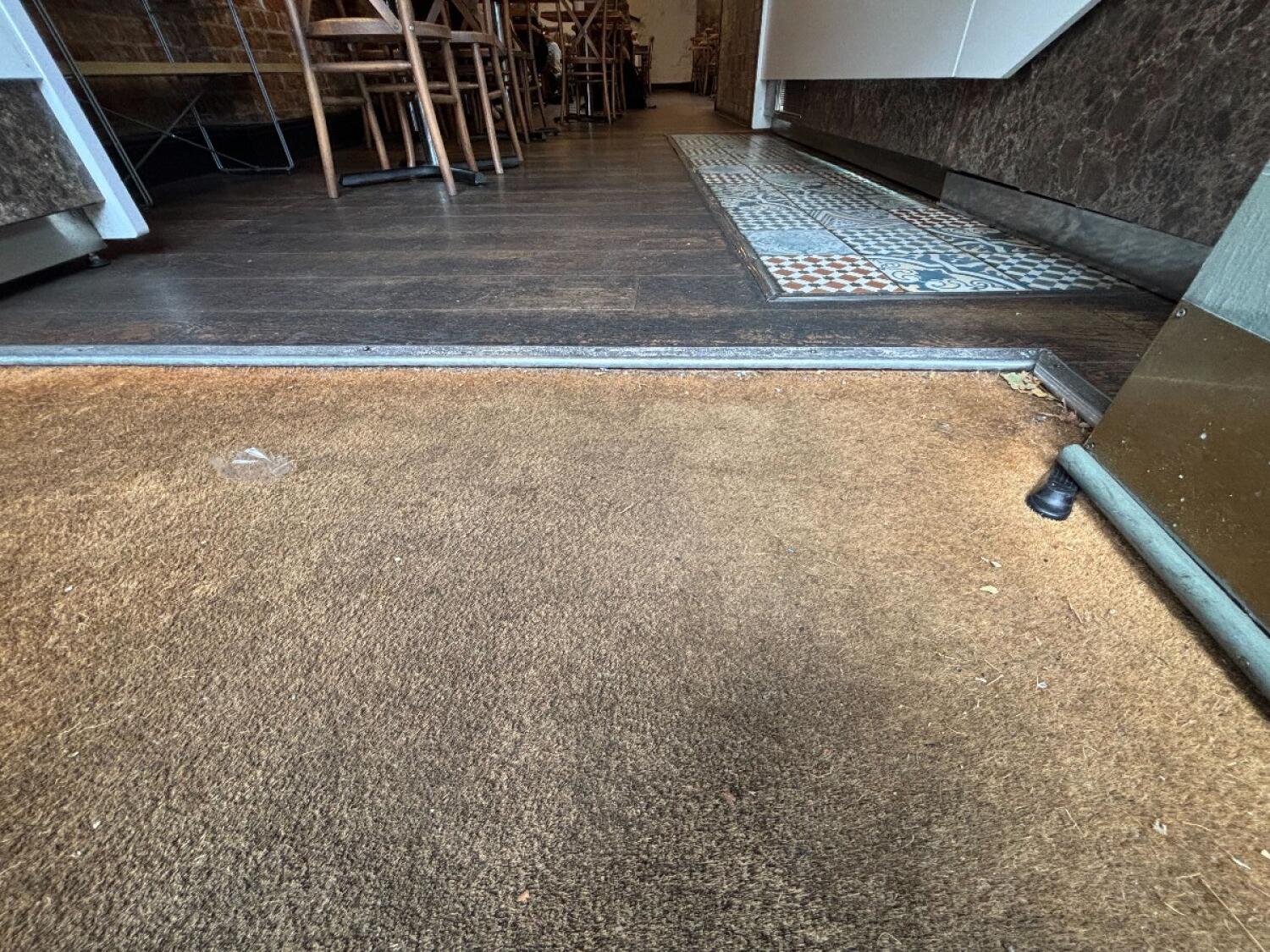Doormat at entrance. Small bump after.