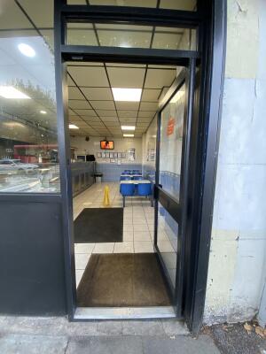 Grey framed glass door. Push from left to open.