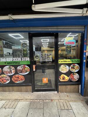 Glass door with black frame ahead. Push from left to open.