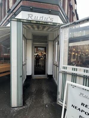 Door with green frame and handle on left. Pull to open.