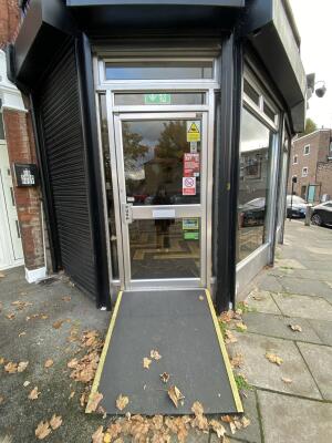 Silver framed glass door ahead. Push from left to open.