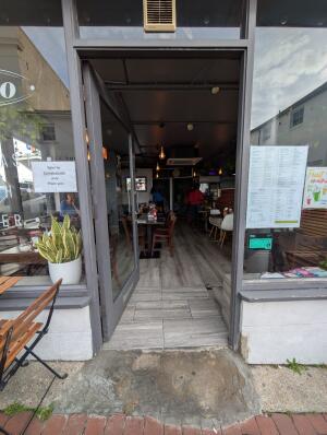 Grey frame glass doors in front. Silver handle on right. Push to open.
