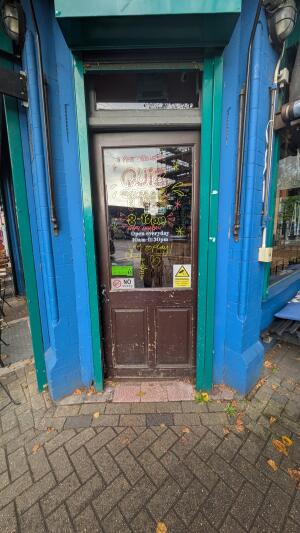 Glass door with wooden frame. Push handle on left to open