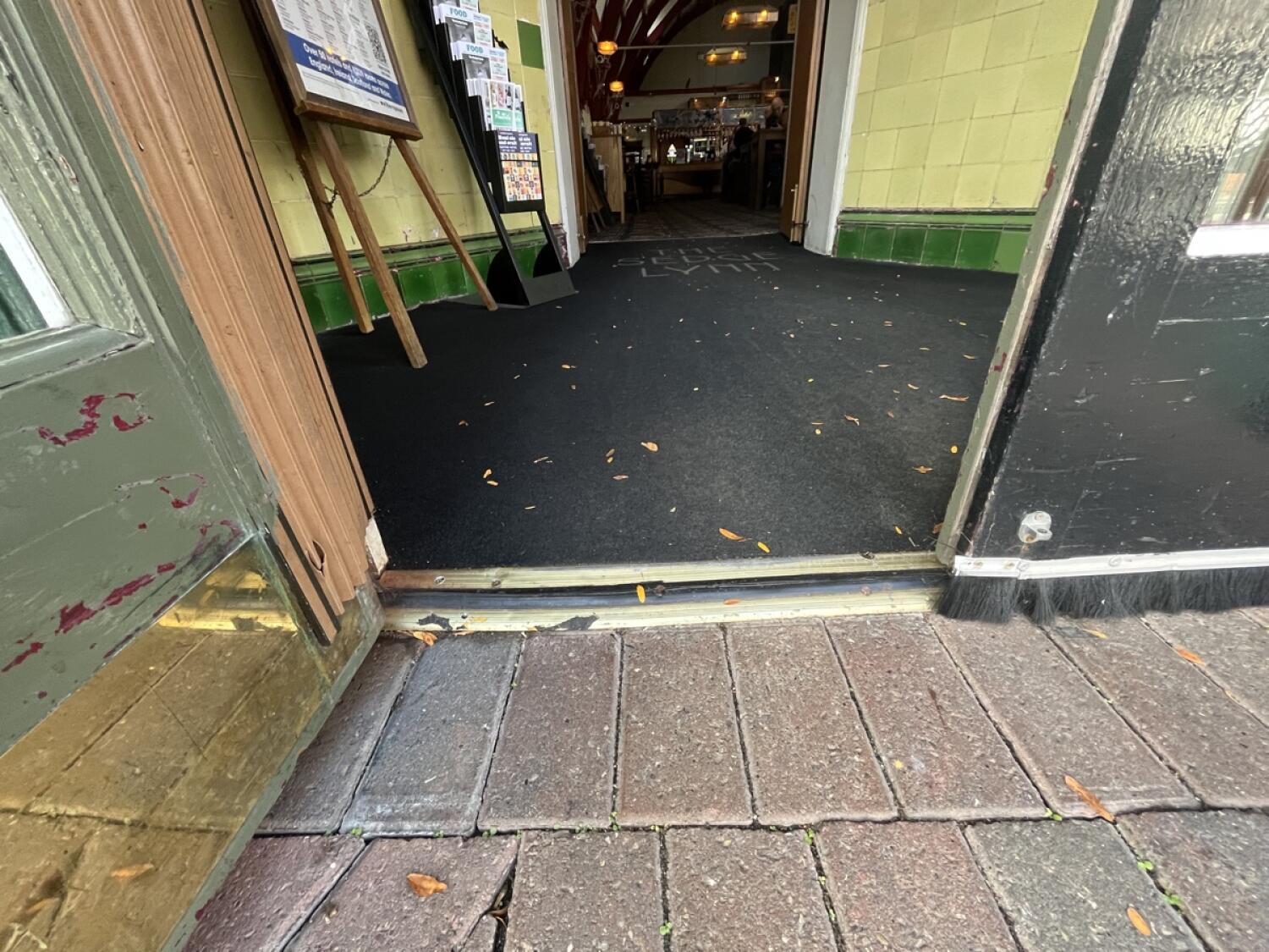 Metal bump at door followed by a carpet.