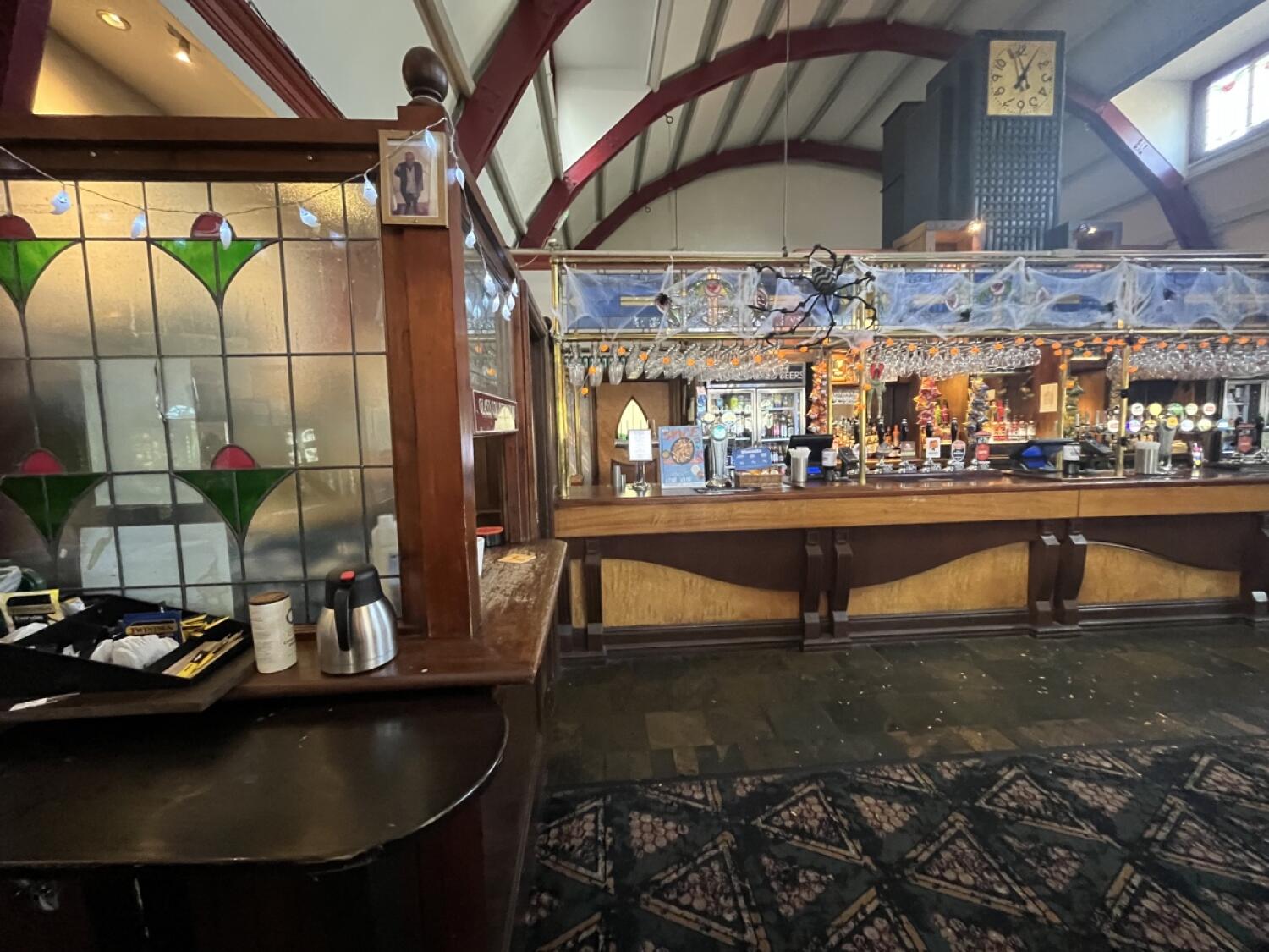 From end of path facing straight. Condiment table on left. Counter at back.
