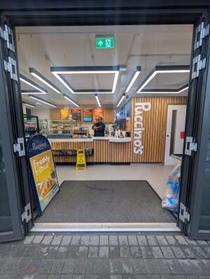Grey frame glass doors in front. Handles in the middle. Pull to open.