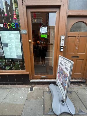 Brown frame glass doors in front. Gold knob on left. Push to open.