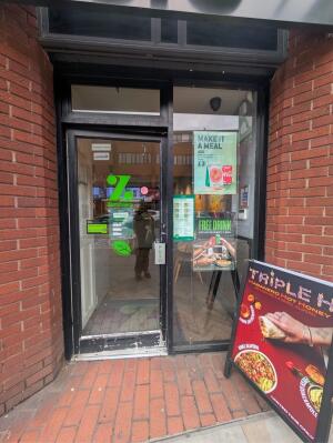 Glass door with black frames ahead Push from right to open. Sign board on right.