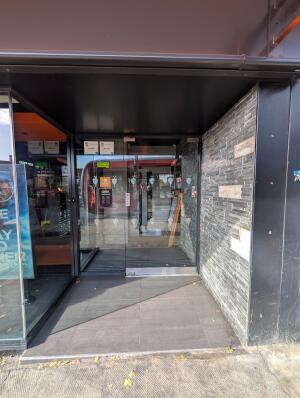Black frame archway in front. Full glass doors in front. Pull from center to open.