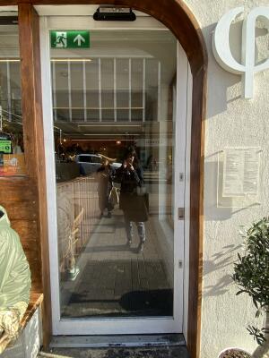 White framed glass sliding door. Automatically open from to left.