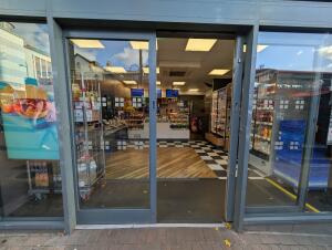 Grey frame glass double doors in front. Slide from center to both sides to open.