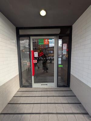 Grey frame glass doors in front. Red handle on left. Pull to open.