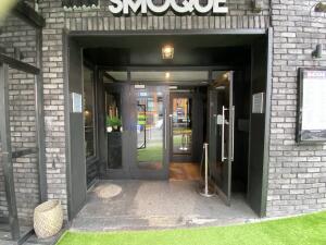 From sidewalk facing the opening. Outdoor space on left. Entrance door at back.