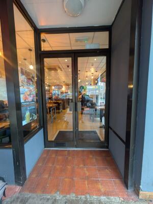 Black frame archway in front. Black frame glass doors at back. Silver handles in center. Pull to open.