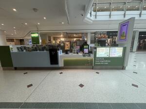 From mall corridor facing venue. Step free access ahead to access venue.