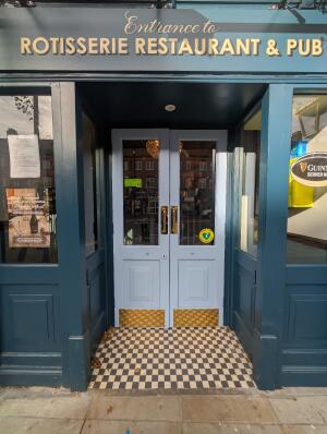 Dark blue archway in front. Light blue wooden doors with glass panels at back. Gold handles in center. Pull to open.