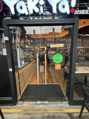 Glass doors with silver handles in middle. Push to open.