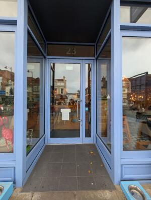 Blue frame archway in front. Blue frame glass doors at back. Silver handle on right. Pull to open.