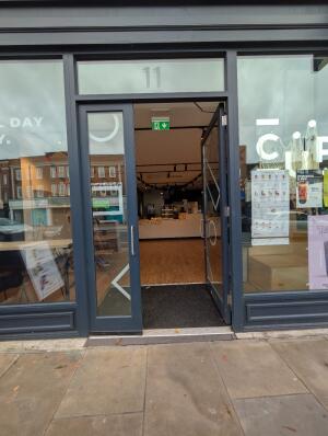 Grey frame glass doors in front. Silver handles on left middle. Push to open.