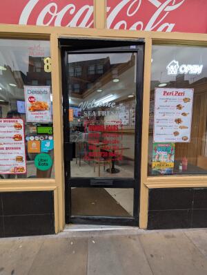 Black frame glass doors in front. Handle on left. Push to open.