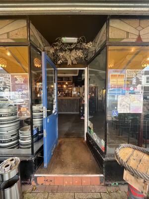 Glass door with a blue wooden part. Handle on right. Pull to open.