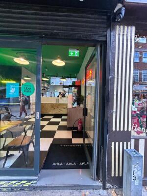 Grey frame glass doors in front. Metal handle on left. Push to open.