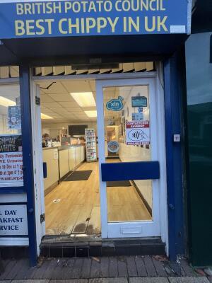Glass double door with a white frame. Push from centre to open.