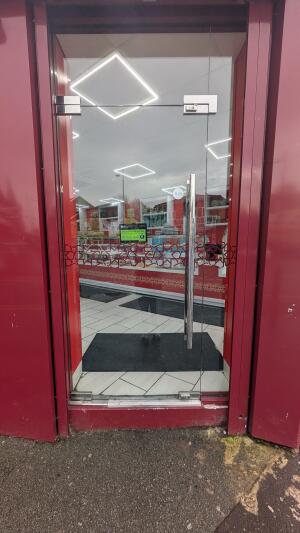 Glass door. Push handle on right to open