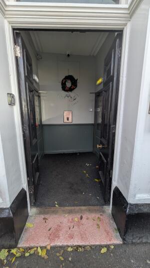 Glass doors with black frames. Push handle in center to open