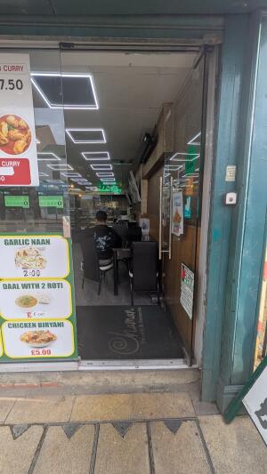 Glass door. Push handle on left to open.