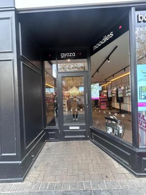 Grey frame archway in front. Grey glass doors at back. Silver handle on right. Pull to open.