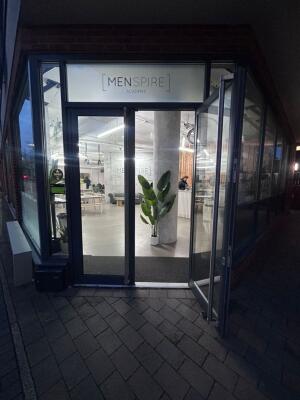 Black frame glass doors in front. Silver handles in the center. Pull to open.