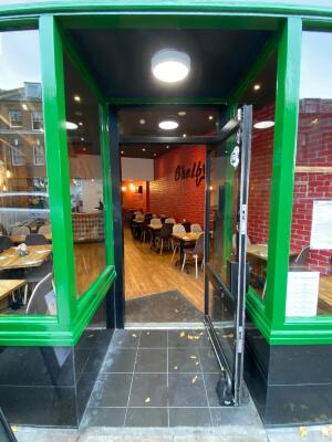 Green frame archway in front. Black frame glass doors at back. Handle on right. Pull to open.