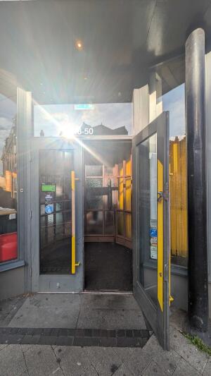 Glass door with gray frame. Pull handle in centre to open.