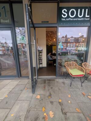 Glass door with grey metal frames ahead. Pull handle on right to open.