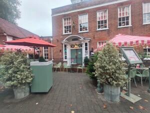 From street facing venue. Path ahead to entrance ahead. Planters on both sides.