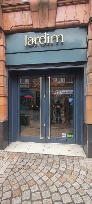 Blue framed glass door with two silver push handles on the front.